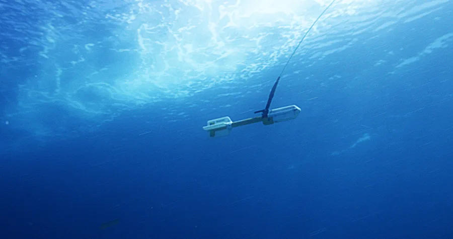 A magnetometer being towed through the water column behind a survey vessel