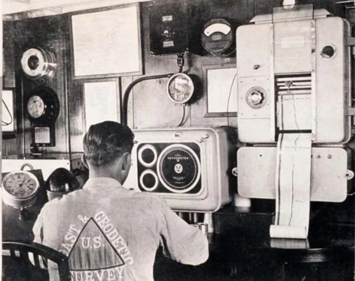 U.S. Coast and Geodetic Survey crewman operating a fathometer in 1935