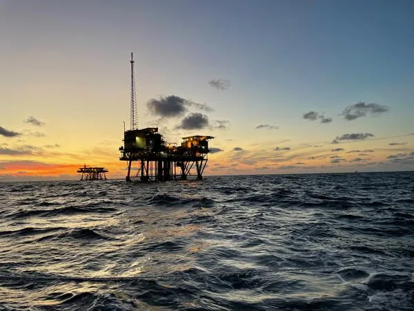 Offshore infrastructure standing in open water at sunset
